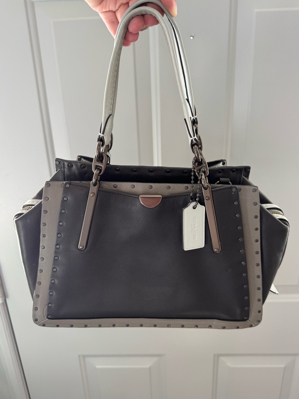 Coach Dreamer 27 color block with rivets Black/gray/blue with gunmetal hardware.